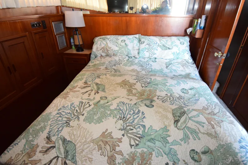 Slide: The Image of Cozy bedroom with ocean-themed bedding in a 1966 Drake 53 boat cabin. - 6
