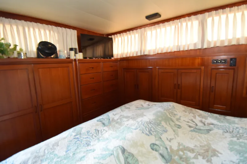 Slide: The Image of Interior of a 1966 Drake 53 yacht with wooden cabinets and a cozy bed. - 7