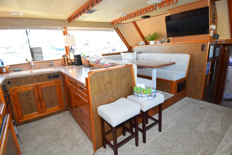 Slide: The Image of Vintage 1966 Drake 53 yacht interior with wood cabinetry, dining area, and modern amenities. - 9