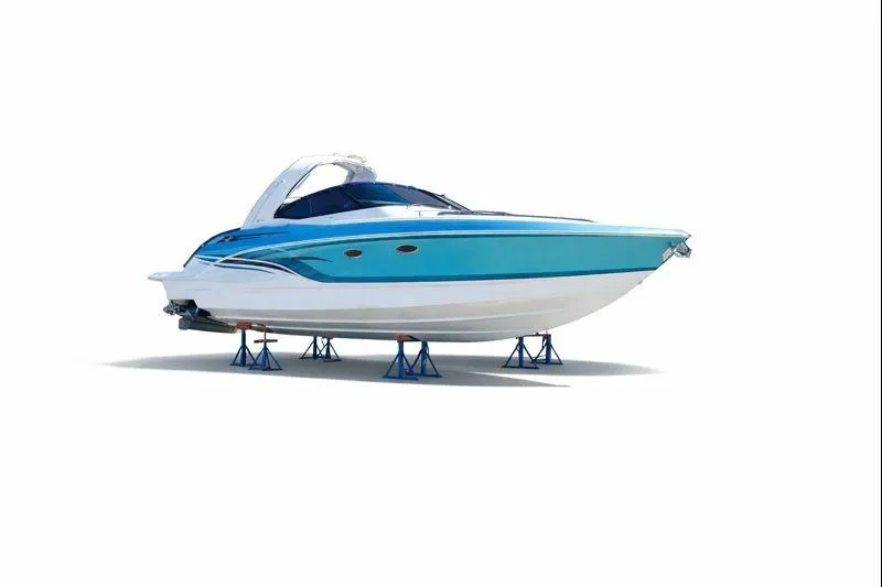 The Image of 2023 Formula 330 Crossover Bowrider I/O, sleek blue design on stands. - 1