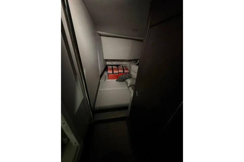 Slide: The Image of Interior cabin of 2023 Formula 330 Crossover Bowrider I/O, featuring cozy seating and cushions. - 10