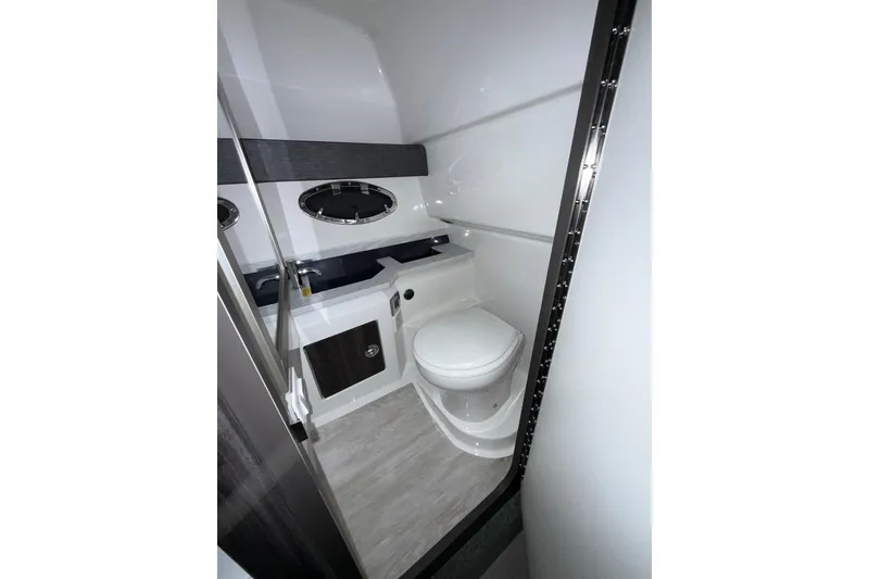 Slide: The Image of 2023 Formula 330 Crossover Bowrider I/O bathroom with modern fixtures and sleek design. - 11