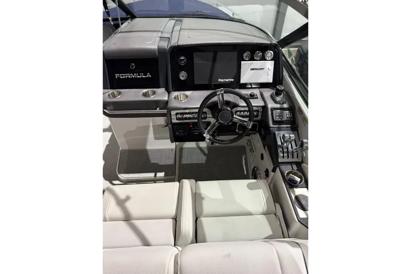 Slide: The Image of 2023 Formula 330 Crossover Bowrider I/O dashboard with steering wheel and control panel. - 17