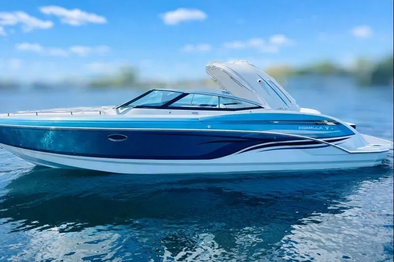 Slide: The Image of 2023 Formula 330 Crossover Bowrider I/O on calm water, showcasing sleek design and vibrant colors. - 3