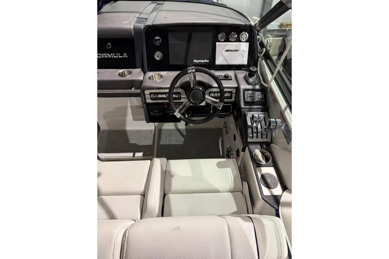 Slide: The Image of 2023 Formula 330 Crossover Bowrider I/O cockpit with modern controls and steering wheel. - 8