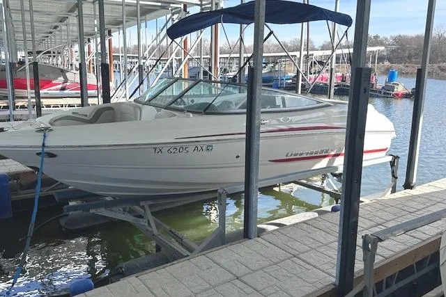 The Image of 2007 Chaparral 190 SSi boat docked at marina with blue canopy. - 0