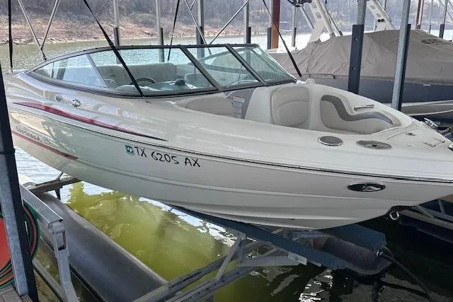 Slide: The Image of 2007 Chaparral 190 SSi boat docked in a marina, side view. - 2