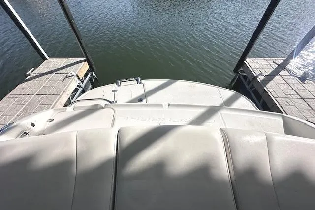 Slide: The Image of 2007 Chaparral 190 SSi boat docked on calm water, viewed from the stern. - 9