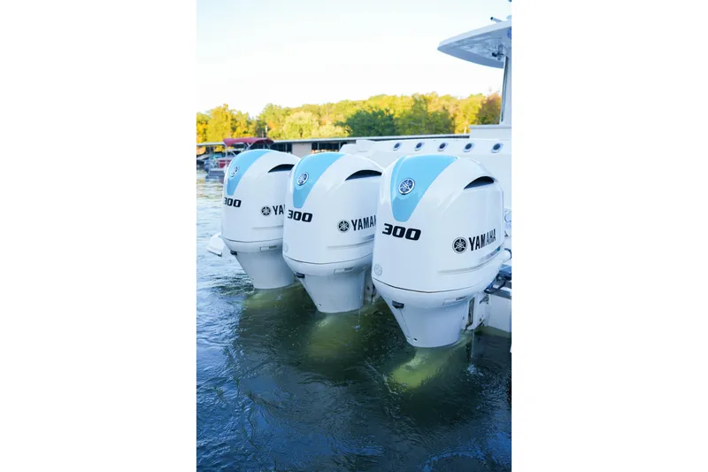 Slide: The Image of Triple Yamaha 300 outboard engines on a 2021 Regal 38 SAV boat in water. - 21