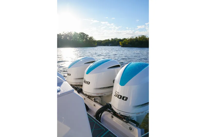 Slide: The Image of Triple Yamaha 300 engines on a 2021 Regal 38 SAV boat, scenic water view. - 24