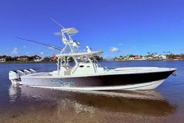 The Image of 2017 Regulator 41 boat with four engines on a sunny day by the shore. - 0