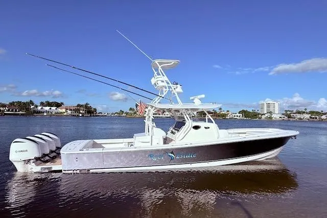 Slide: The Image of 2017 Regulator 41 boat with triple Yamaha engines on a sunny day. - 1