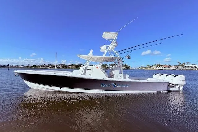 Slide: The Image of 2017 Regulator 41 boat on water, clear sky, fishing rods visible. - 17