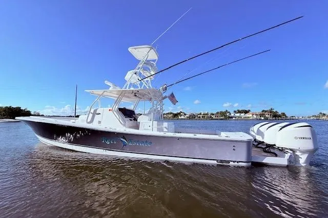 Slide: The Image of 2017 Regulator 41 boat with triple Yamaha engines on calm water. - 18