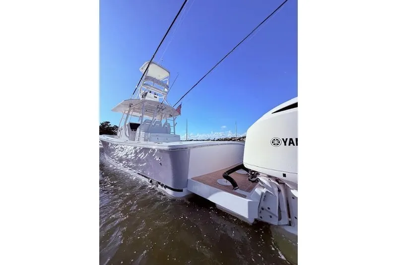 Slide: The Image of 2017 Regulator 41 boat with Yamaha engine cruising on water under clear blue sky. - 19