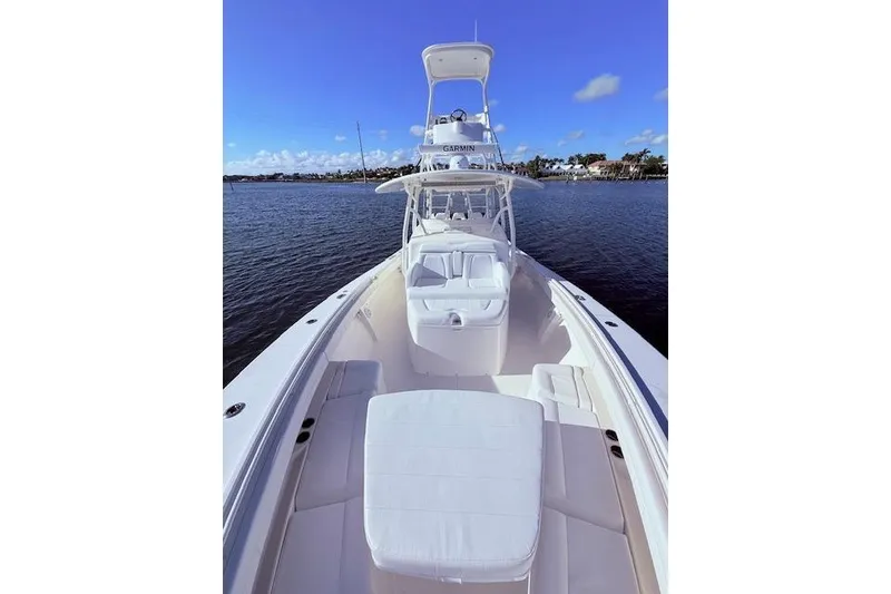 Slide: The Image of 2017 Regulator 41 boat on calm water, clear sky, luxurious seating. - 24