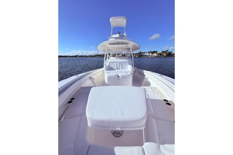 Slide: The Image of 2017 Regulator 41 boat with white seating, on calm water under a clear blue sky. - 25