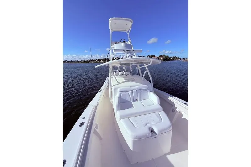 Slide: The Image of 2017 Regulator 41 boat on water, featuring sleek white seating and Garmin equipment. - 26