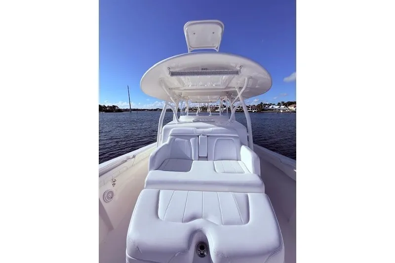 Slide: The Image of 2017 Regulator 41 boat with white seating, on calm water under clear blue sky. - 27