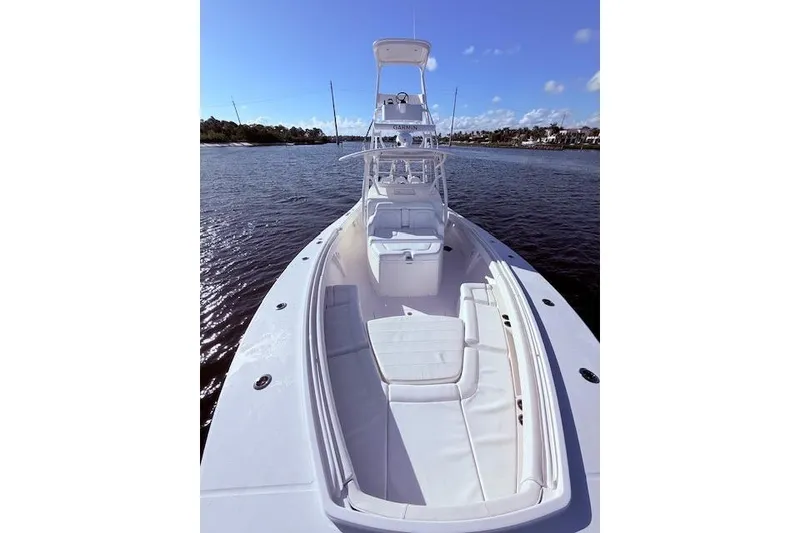 Slide: The Image of 2017 Regulator 41 boat on water, featuring spacious deck and seating. - 28