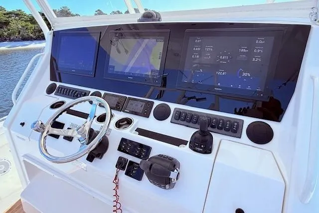 Slide: The Image of Control panel of a 2017 Regulator 41 boat with advanced navigation displays. - 32