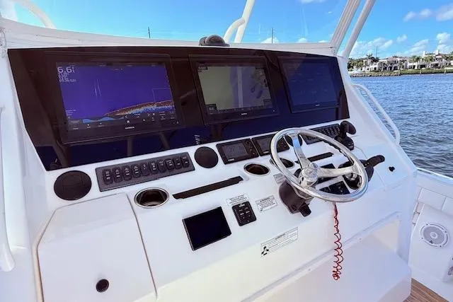 Slide: The Image of Control panel of a 2017 Regulator 41 boat with navigation screens and steering wheel. - 33