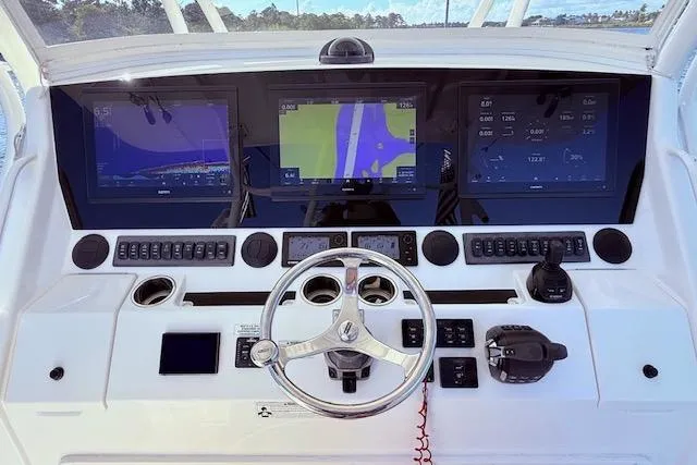 Slide: The Image of Control panel of a 2017 Regulator 41 boat with advanced navigation displays. - 34