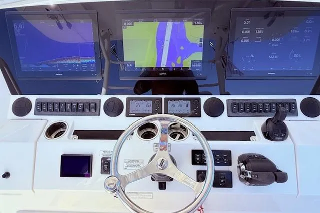 Slide: The Image of 2017 Regulator 41 boat dashboard with navigation screens and controls. - 35