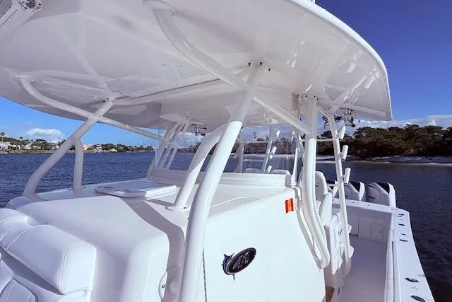 Slide: The Image of 2017 Regulator 41 boat with sleek white design, docked on calm waters. - 41