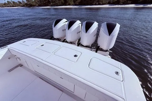 Slide: The Image of 2017 Regulator 41 boat with four powerful outboard engines on calm water. - 47