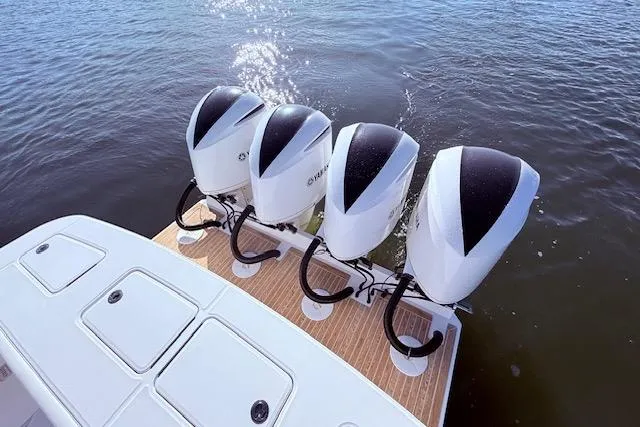 Slide: The Image of Four powerful outboard engines on a 2017 Regulator 41 boat, glistening on the water. - 49