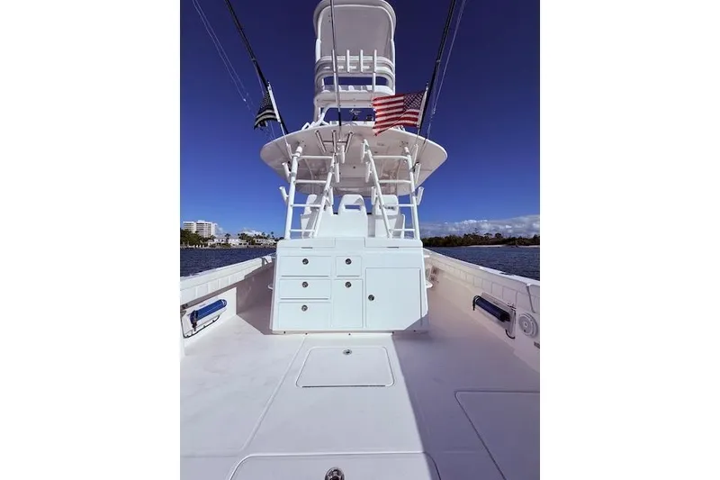 Slide: The Image of 2017 Regulator 41 boat deck with tower, American flag, and clear blue sky. - 53