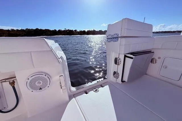 Slide: The Image of 2017 Regulator 41 boat interior with water view, featuring seating and speaker. - 55