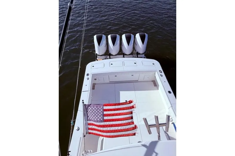 Slide: The Image of 2017 Regulator 41 boat with four engines and American flag on deck. - 57