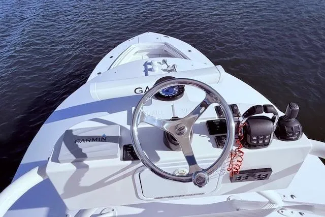 Slide: The Image of 2017 Regulator 41 boat helm with Garmin navigation system on calm water. - 58