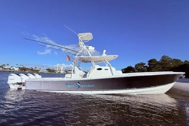 Slide: The Image of 2017 Regulator 41 boat with triple engines on calm water under clear blue sky. - 6