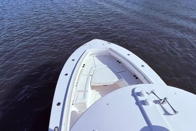 Slide: The Image of 2017 Regulator 41 boat bow on calm water, showcasing sleek design and spacious seating. - 60