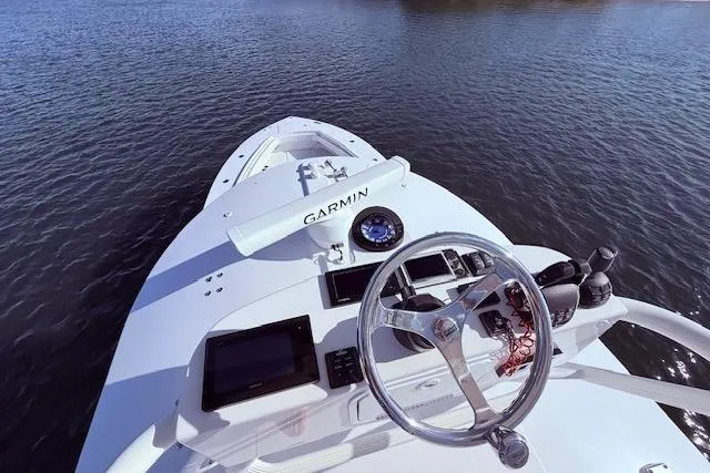 Slide: The Image of 2017 Regulator 41 boat helm with Garmin navigation on calm water. - 63