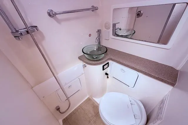 Slide: The Image of Luxurious bathroom in 2017 Regulator 41 boat with modern fixtures and glass sink. - 78