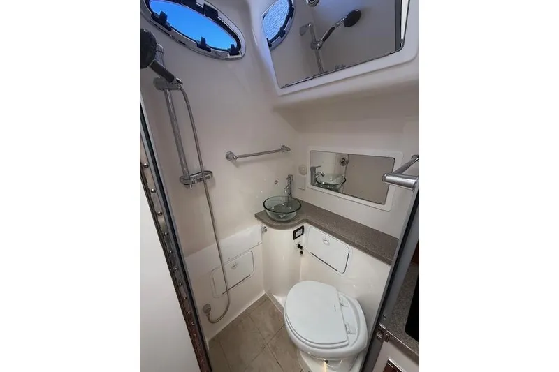 Slide: The Image of 2017 Regulator 41 boat bathroom with shower, sink, and toilet. - 79