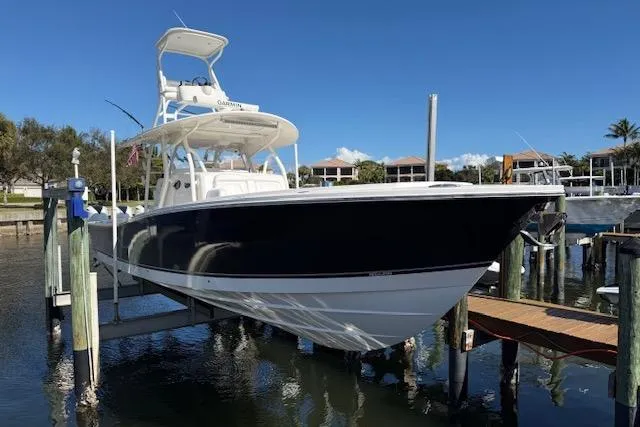 Slide: The Image of 2017 Regulator 41 boat docked, featuring sleek design and elevated helm station. - 80
