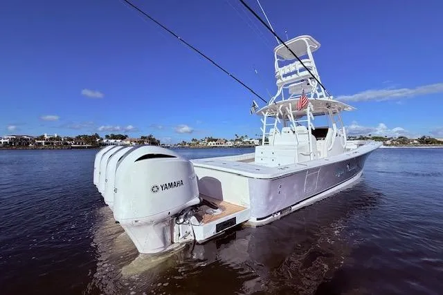 Slide: The Image of 2017 Regulator 41 boat with Yamaha engines on calm water under clear blue sky. - 9