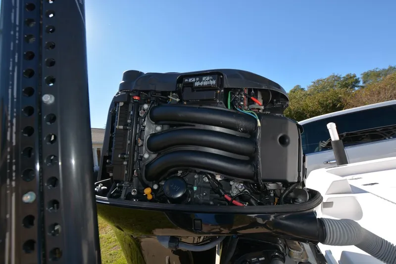 Slide: The Image of 2013 Contender 25 Bay boat engine, detailed view under clear blue sky. - 12