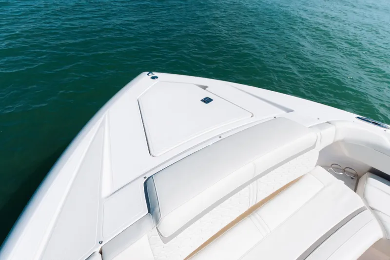 Slide: The Image of Bow of 2023 Tiara 48 yacht with white seating, on calm blue water. - 18