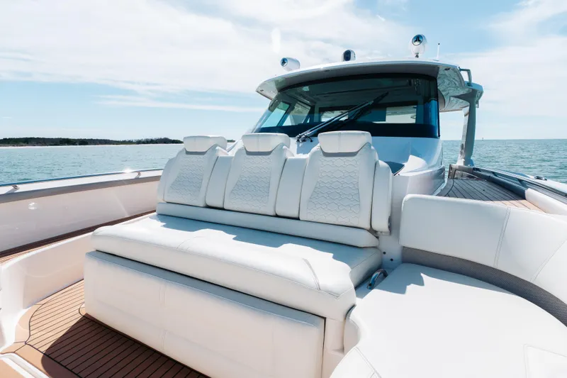 Slide: The Image of Luxurious 2023 Tiara 48 yacht with elegant white seating on a sunny day at sea. - 20