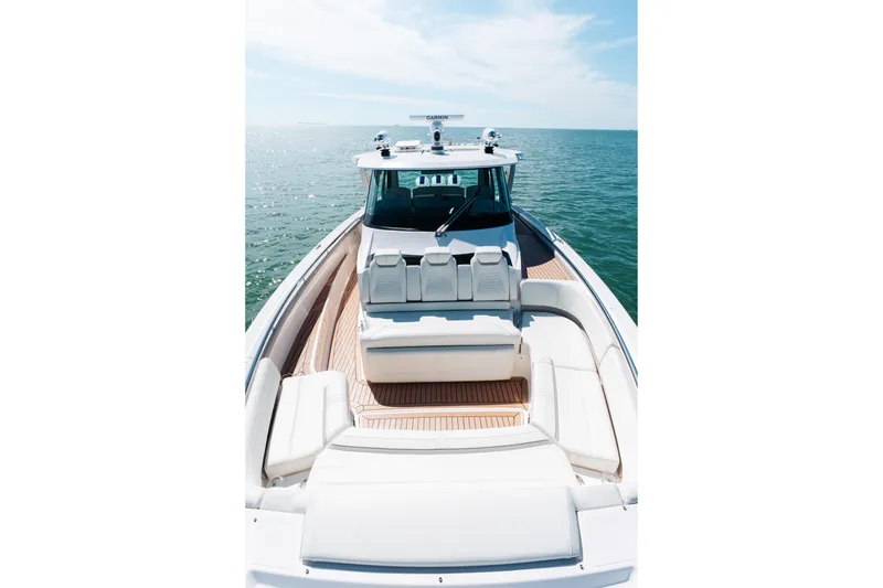 Slide: The Image of 2023 Tiara 48 yacht on open water, showcasing luxurious deck seating. - 22
