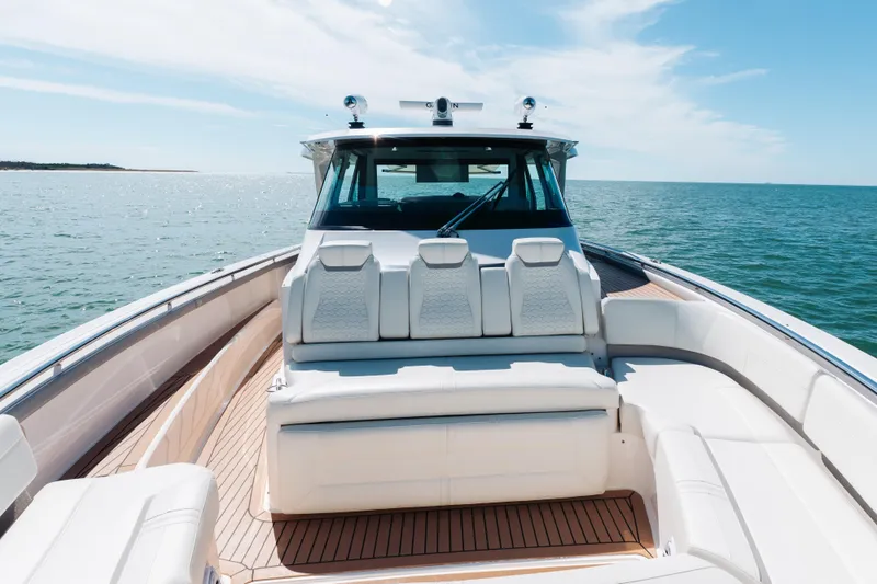 Slide: The Image of Luxurious 2023 Tiara 48 yacht with spacious seating on open water. - 23