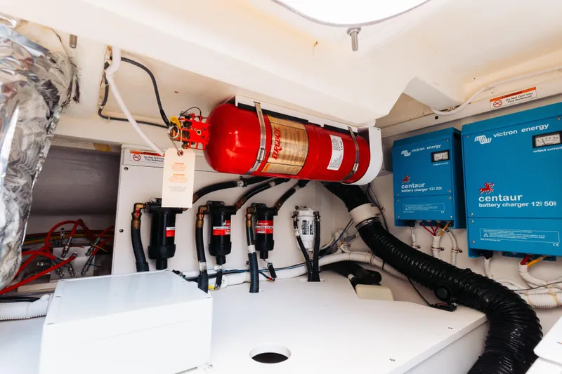 Slide: The Image of Engine room of 2023 Tiara 48 yacht with fire extinguisher and battery chargers. - 29
