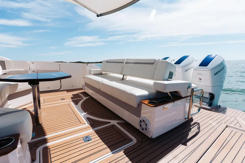 Slide: The Image of Luxurious 2023 Tiara 48 yacht deck with seating and Mercury outboard engines. - 38