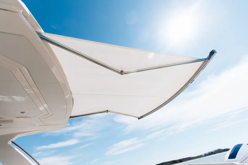 Slide: The Image of 2023 Tiara 48 yacht with sunshade under clear blue sky. - 39